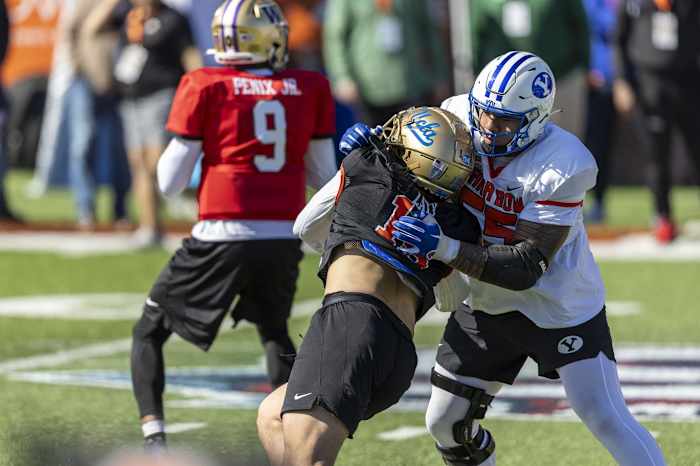 Jan 30, 2024; Mobile, AL, USA; National offensive lineman Kingsley Suamataia of Byu (55) battles National edge Laiatu Latu of Ucla (15) during practice for the National team at Hancock Whitney Stadium.